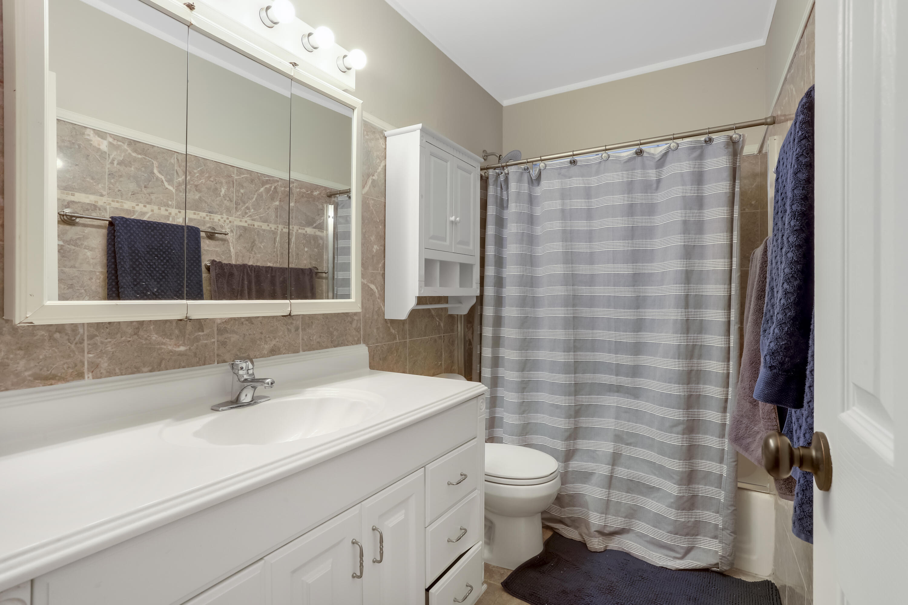 1346 Northwest 4th Street Boca Raton, FL 33486 - Photo 21 of 33 a bathroom with a sink a toilet a mirror and shower
