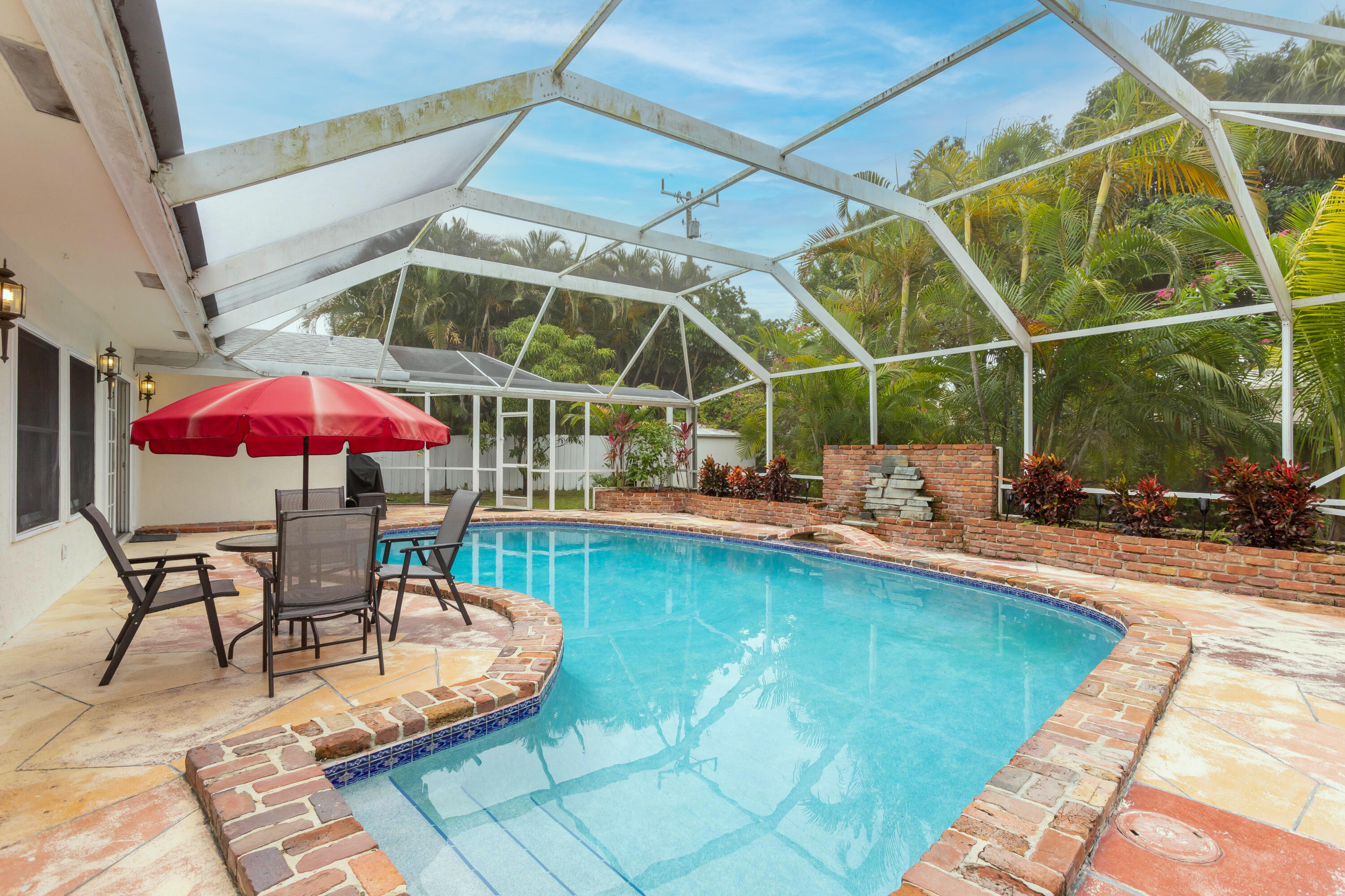 1346 Northwest 4th Street Boca Raton, FL 33486 - Photo 24 of 33 a view of a swimming pool with a patio