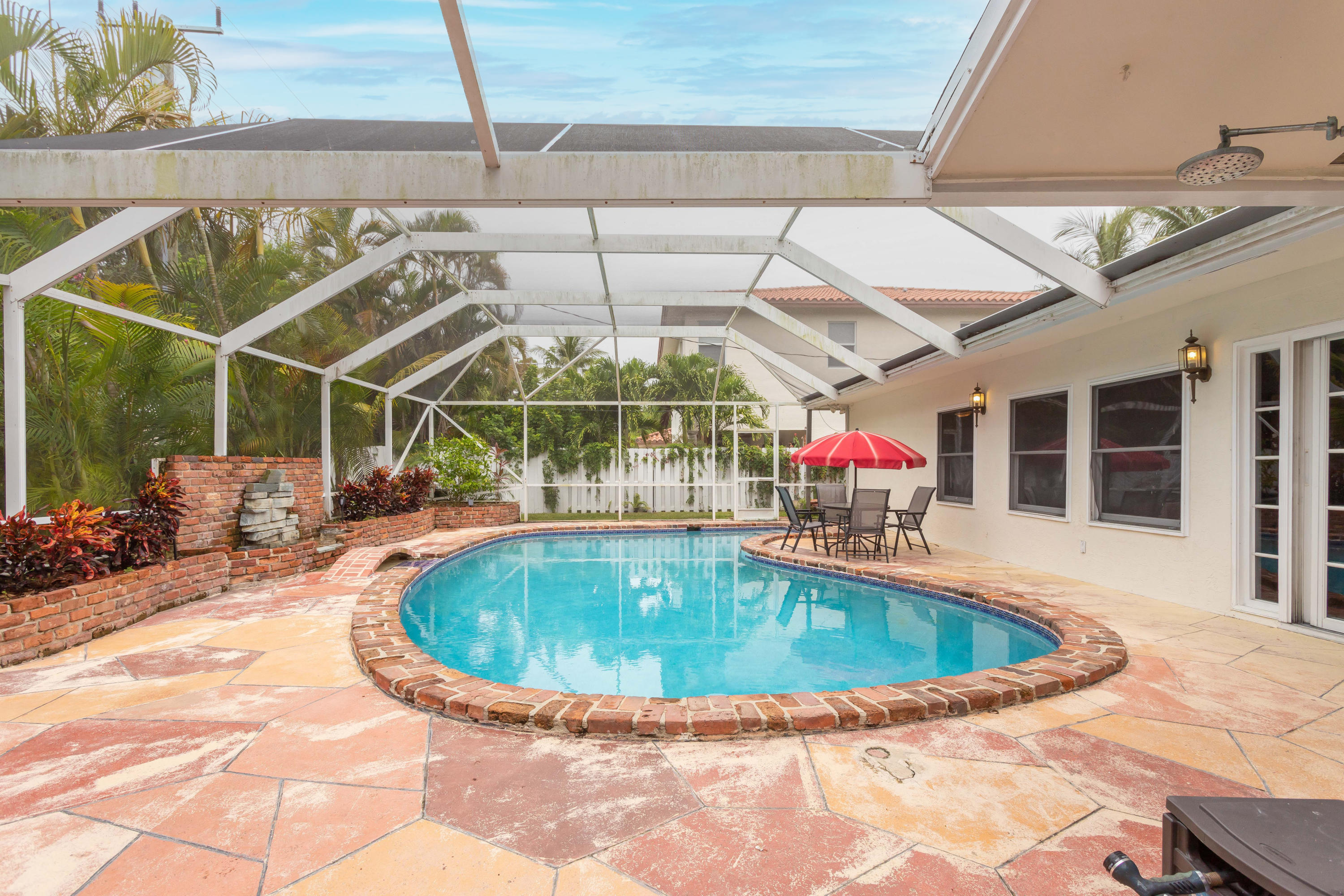1346 Northwest 4th Street Boca Raton, FL 33486 - Photo 25 of 33 a view of a swimming pool with a patio