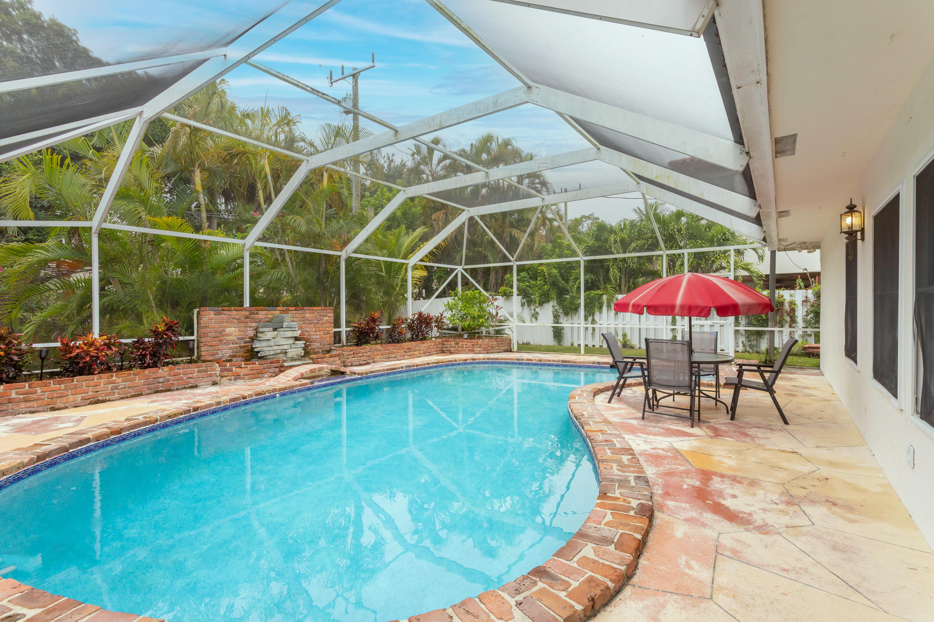 1346 Northwest 4th Street Boca Raton, FL 33486 - Photo 27 of 33 a view of a swimming pool with a patio