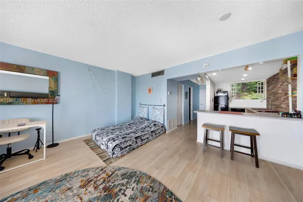 a bedroom with furniture and a wooden floor