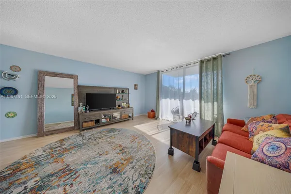 a bedroom with furniture and a flat screen tv