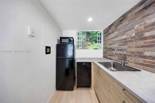 a kitchen with stainless steel appliances granite countertop a refrigerator a sink a stove and washer