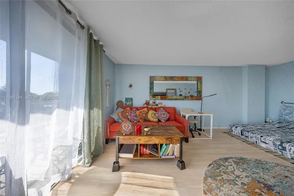 a bedroom with a bed and glass windows