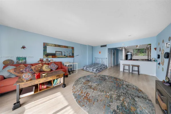 a bedroom with furniture and a wooden floor