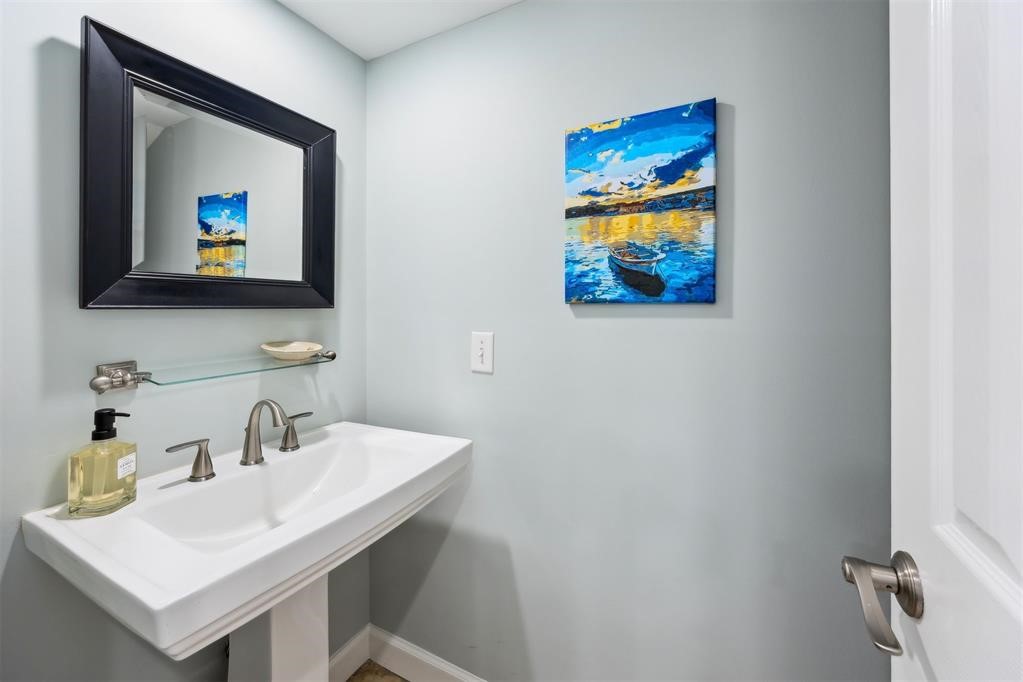 3033 Sea Marsh Road Fernandina Beach, FL 32034 - Photo 18 of 37 a bathroom with a sink mirror and a picture on the wall