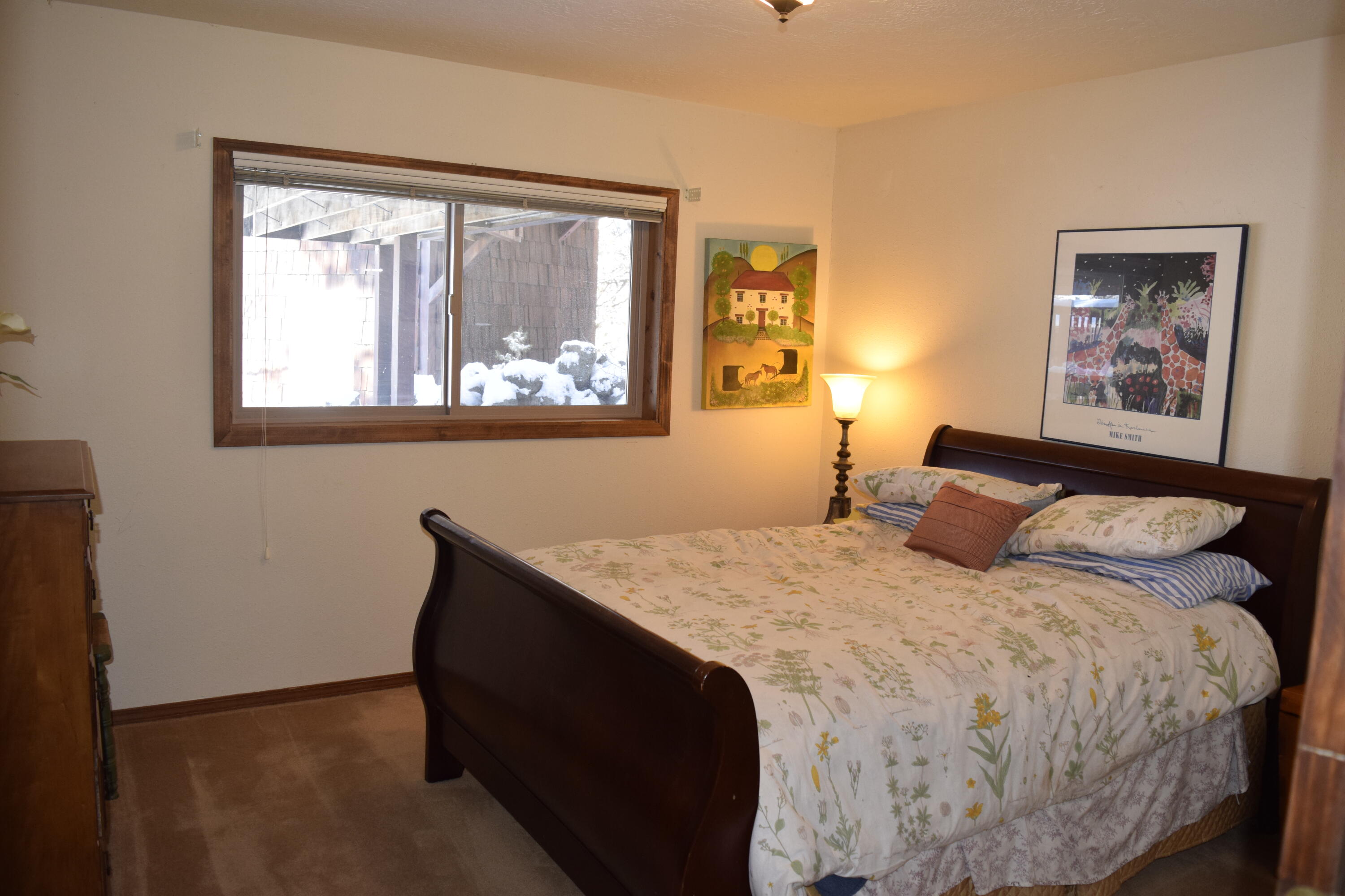 64295 Schibel Road Bend, OR 97703 - Photo 22 of 41 a bedroom with a bed and a window