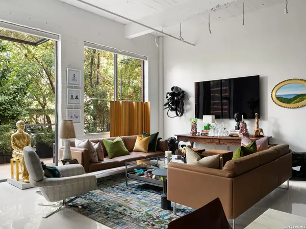 a living room with furniture and a floor to ceiling window