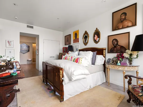 a bedroom with a bed and dresser