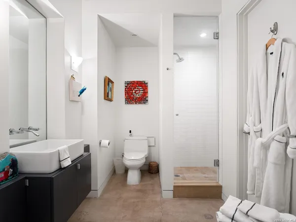 a bathroom with a toilet sink and shower