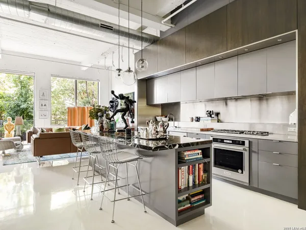 a kitchen with stainless steel appliances granite countertop a stove and a refrigerator