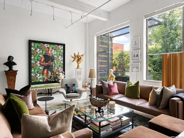 a living room with furniture and large window