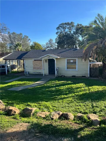 a front view of a house with a garden