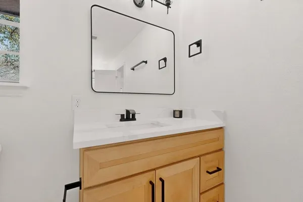 a bathroom with a sink and a mirror