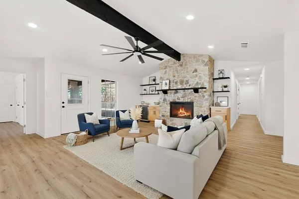 a living room with furniture wooden floor and a fireplace