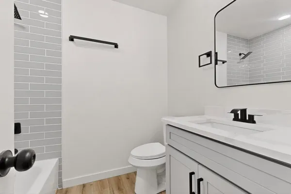 a bathroom with a sink toilet and vanity