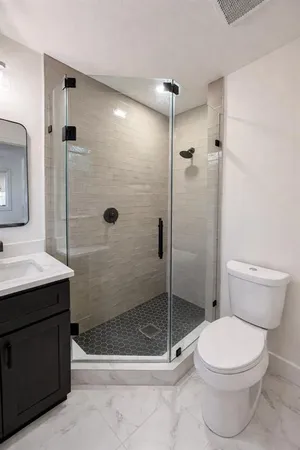 a bathroom with a toilet a sink and shower