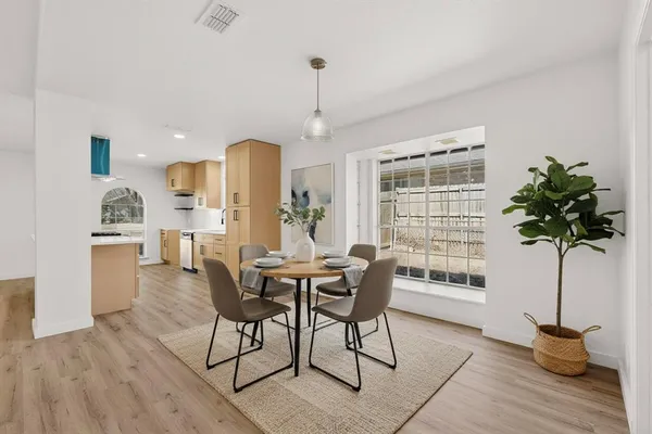 a view of a dining room with furniture window and wooden floor