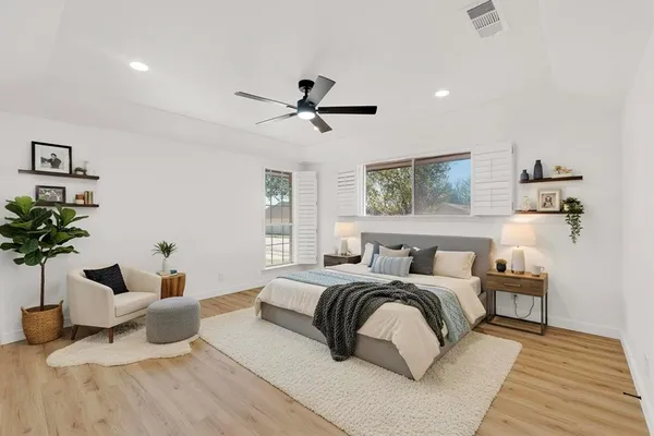 a bedroom with a bed and a potted plant