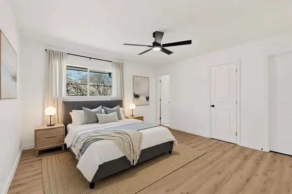 a bedroom with a bed and a painting on the wall