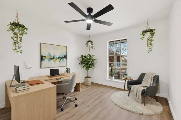 a workspace with furniture and a potted plant
