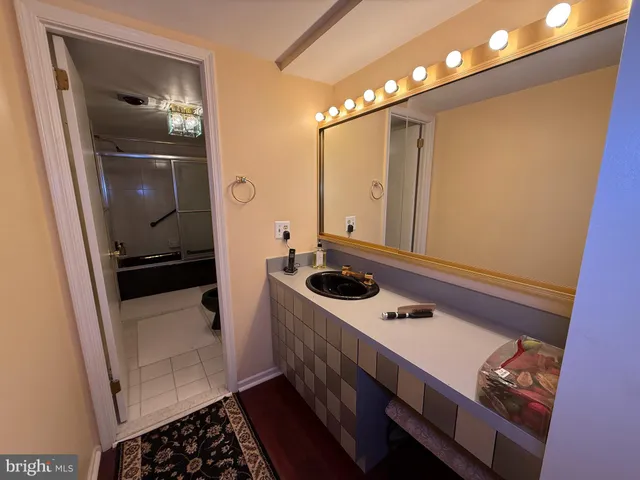 a bathroom with a sink a mirror and vanity