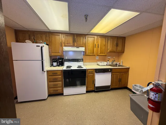a kitchen with stainless steel appliances a refrigerator sink and cabinets