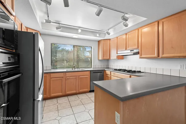 a kitchen with a sink dishwasher and cabinets