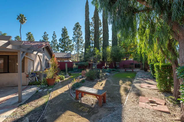 a view of a house with a small yard and plants
