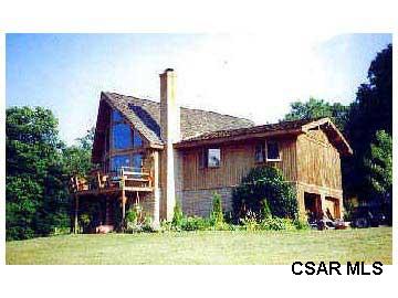 635 Hatch Hollow Road Rockwood, PA 15557 - Photo 1 of 1 a front view of a house with a garden