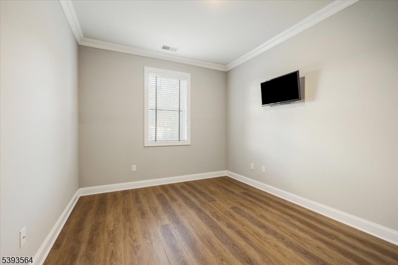 205 Mariners Pointe Hopatcong, NJ 07843 - Photo 18 of 31 a view of room with wooden floor and fan
