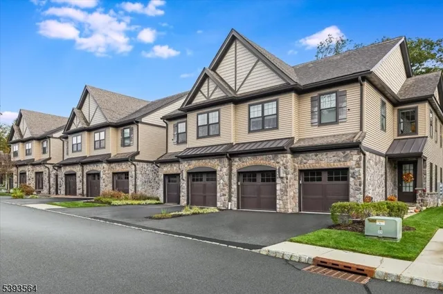 an aerial view of a house with a garden and lake view