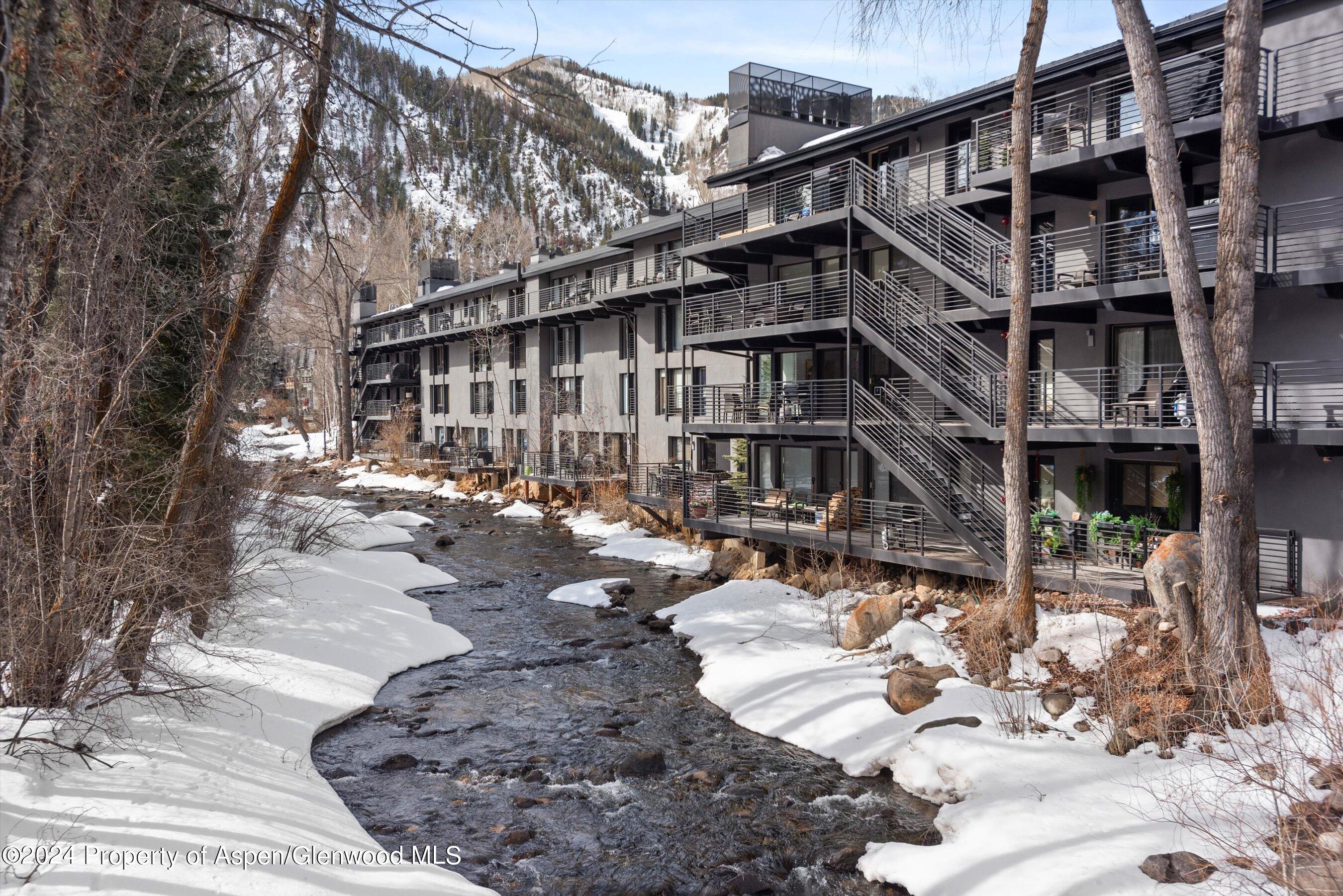 1039 East Cooper Avenue, Unit 19B Aspen, CO 81611 - Photo 12 of 13 a view of a building with yard and sitting area