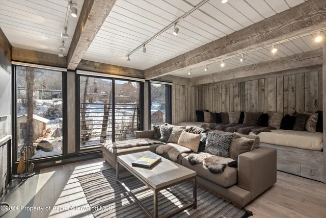 a living room with furniture and a floor to ceiling window