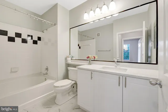 a bathroom with a bathtub shower