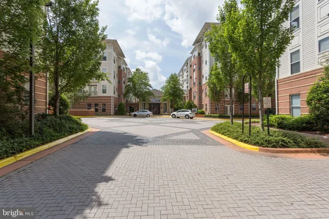 a living room with furniture a flat screen tv and a large window