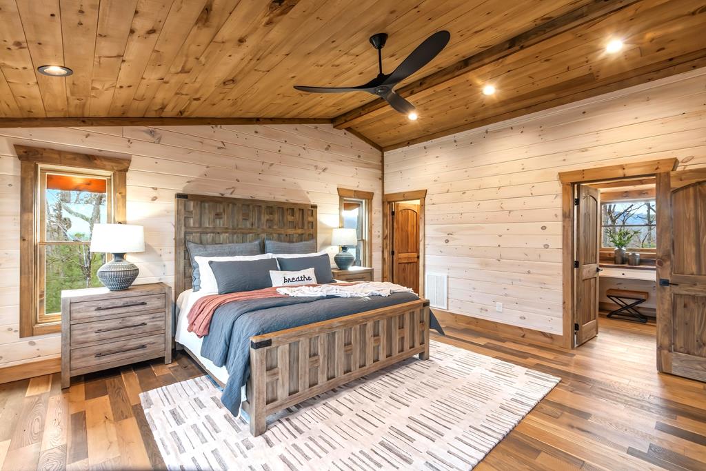 470 Skylight Drive Blue Ridge, GA 30513 - Photo 35 of 83 a bedroom with a large bed and a wooden floor