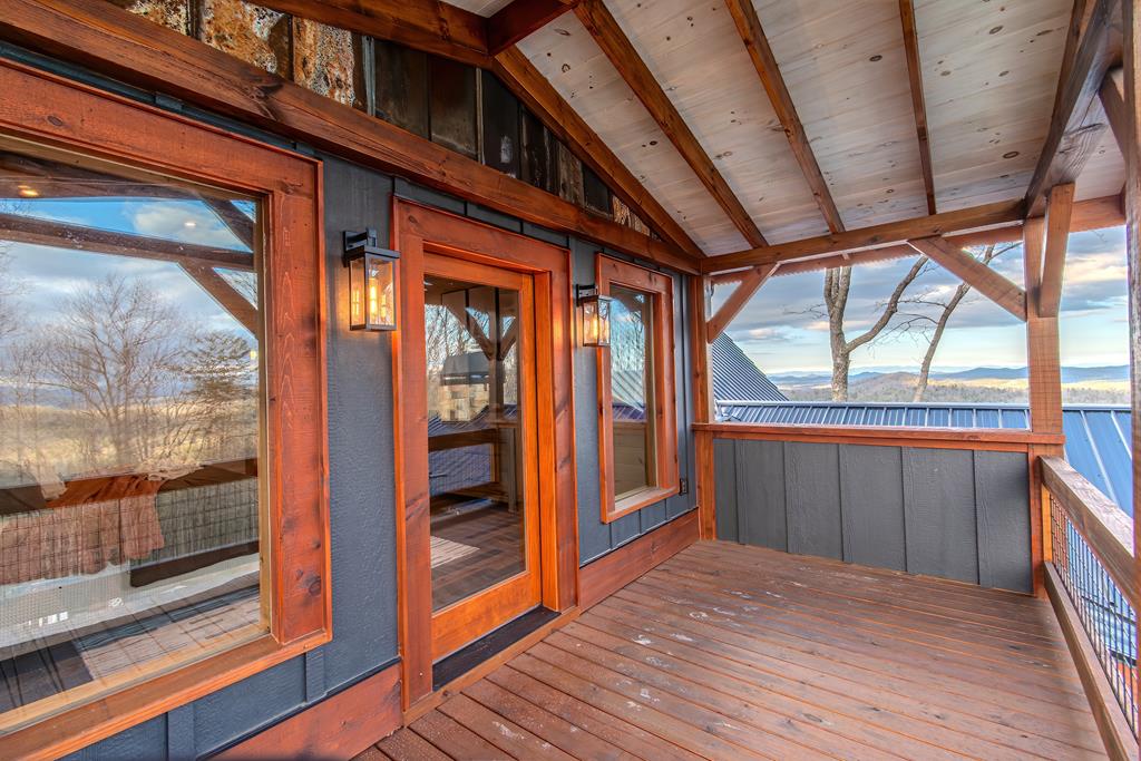 470 Skylight Drive Blue Ridge, GA 30513 - Photo 36 of 83 a view of a porch with wooden floor and a gate