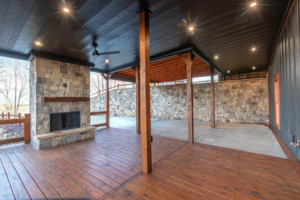 470 Skylight Drive Blue Ridge, GA 30513 - Photo 75 of 83 a view of empty room with wooden floor and fireplace