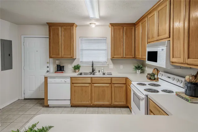 a kitchen with sink a stove and cabinets
