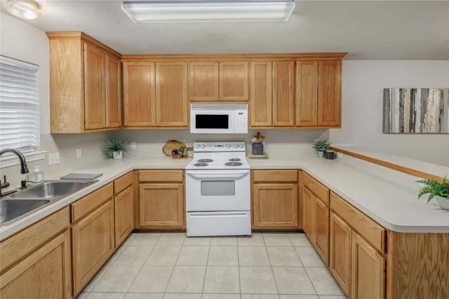 a kitchen with a stove sink and cabinets