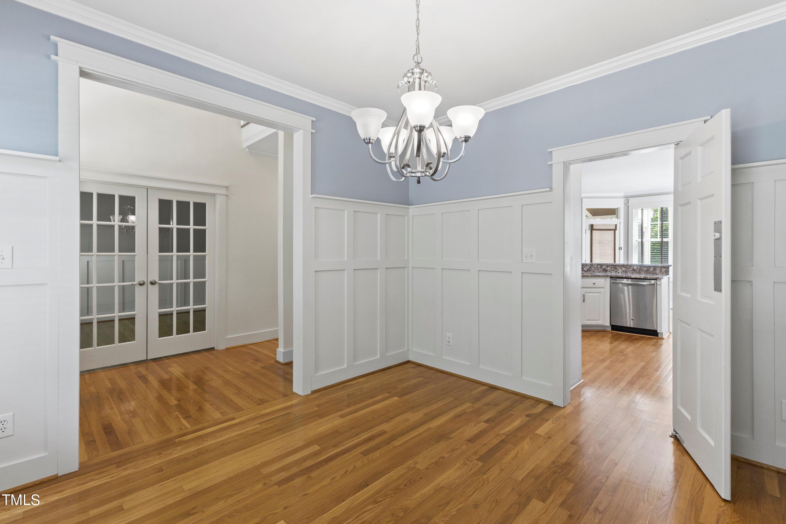 7408 Lakefall Drive Wake Forest, NC 27587 - Photo 11 of 65 a view of a livingroom with wooden floor and a kitchen space
