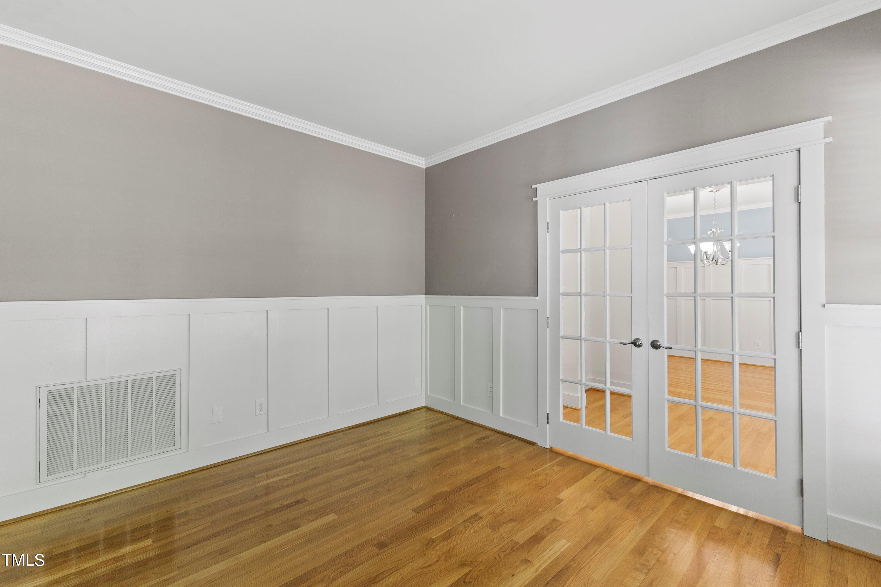 7408 Lakefall Drive Wake Forest, NC 27587 - Photo 13 of 65 a view of an empty room with wooden floor and a window