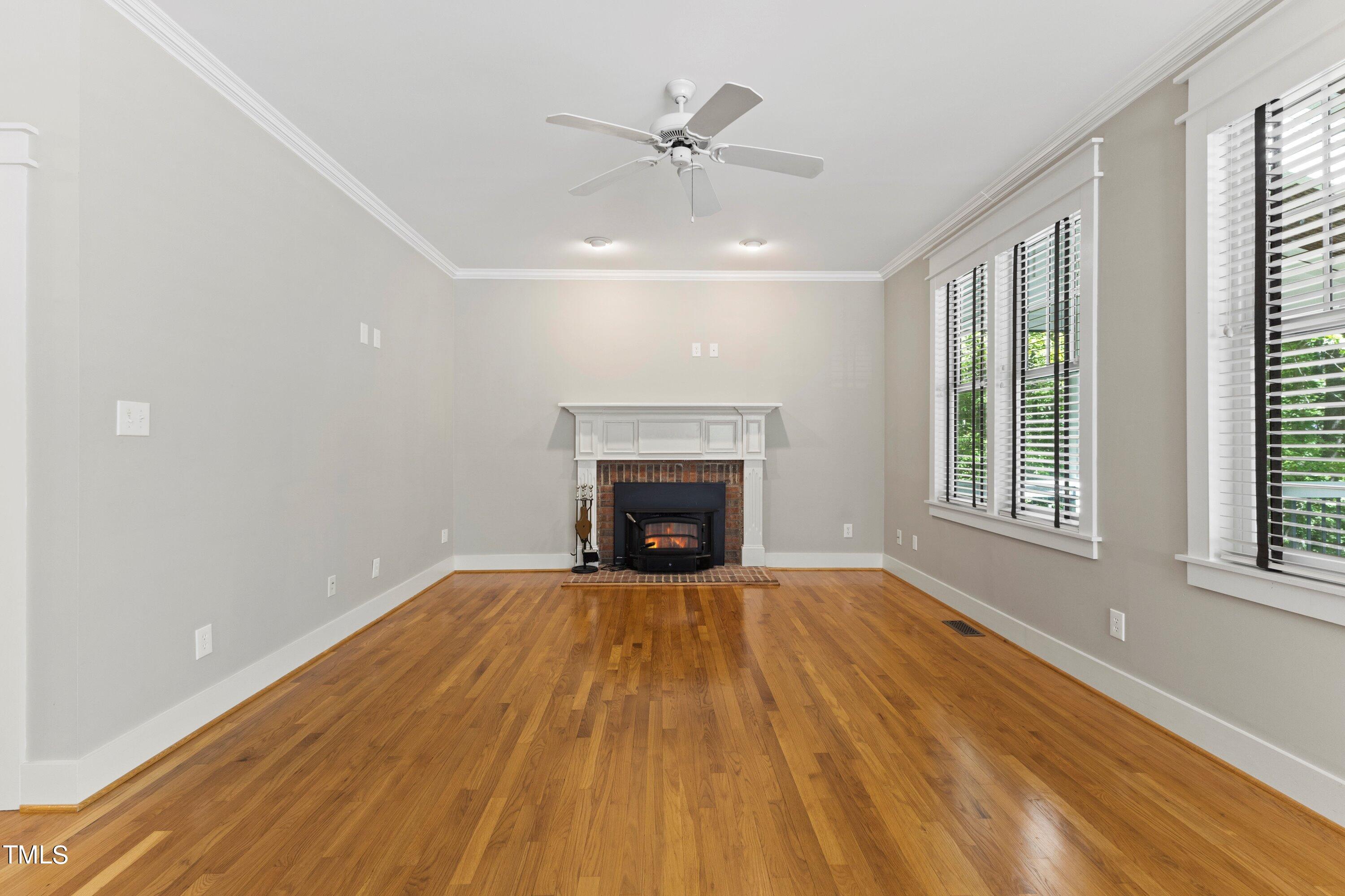 7408 Lakefall Drive Wake Forest, NC 27587 - Photo 16 of 65 a view of an empty room with a fireplace and a window