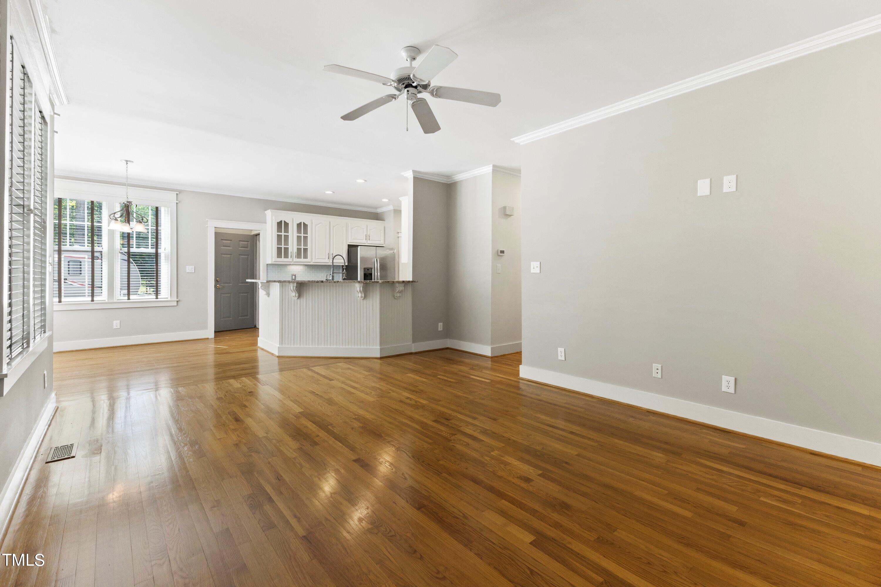 7408 Lakefall Drive Wake Forest, NC 27587 - Photo 17 of 65 a view of a kitchen with a dishwasher cabinets and a floor to ceiling window