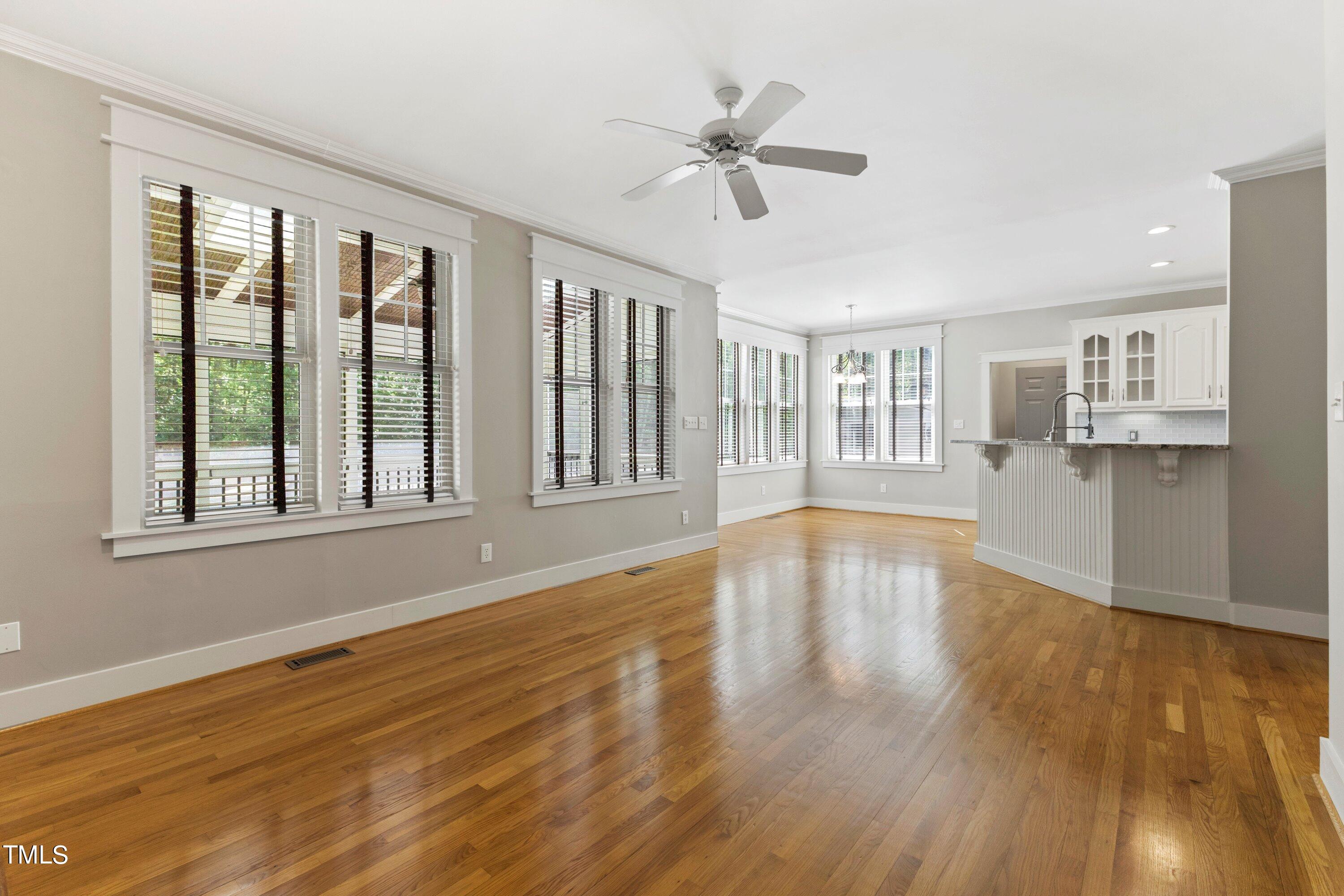 7408 Lakefall Drive Wake Forest, NC 27587 - Photo 18 of 65 a view of an empty room with wooden floor and a window