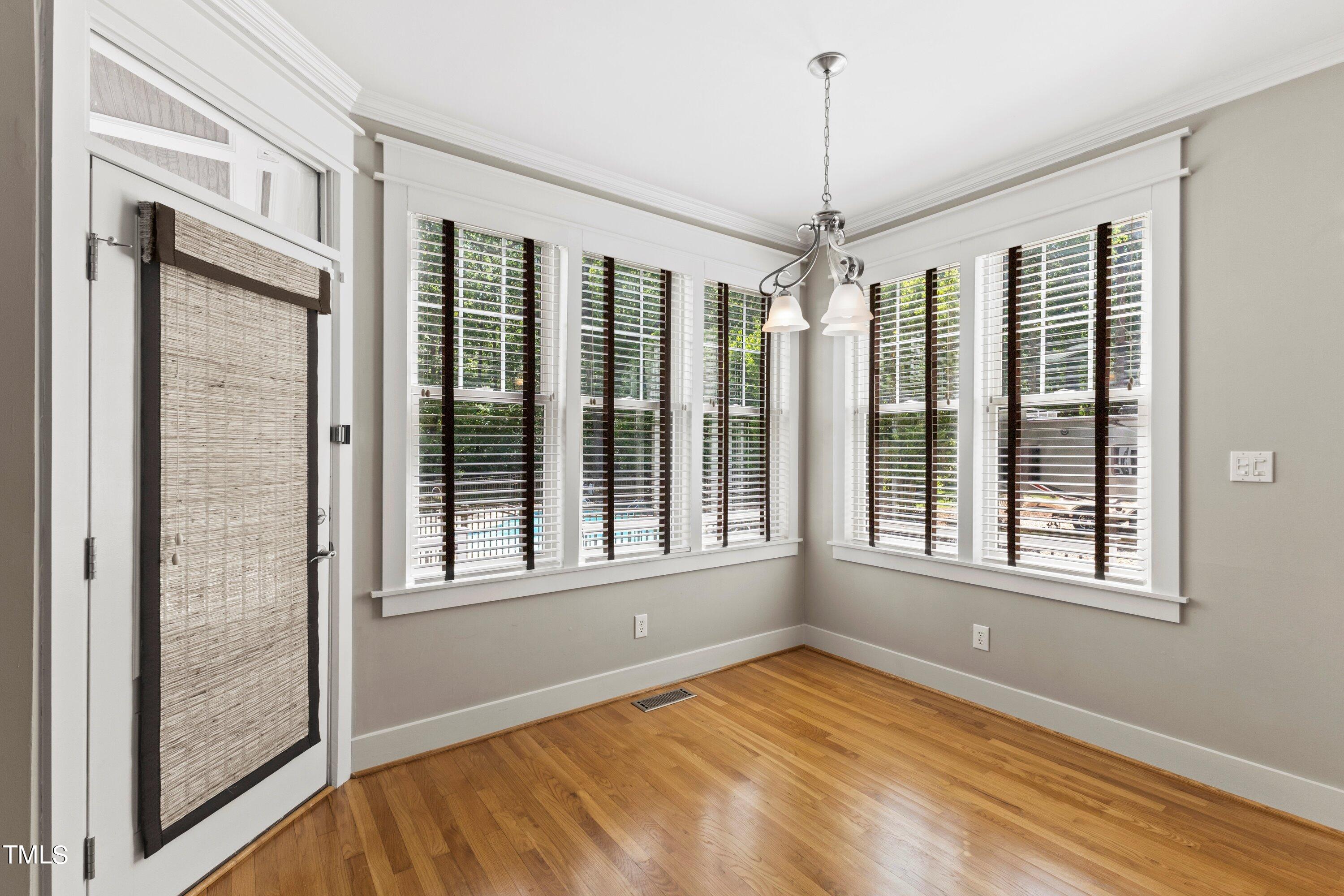 7408 Lakefall Drive Wake Forest, NC 27587 - Photo 19 of 65 a view of an empty room with a window and hardwood floor