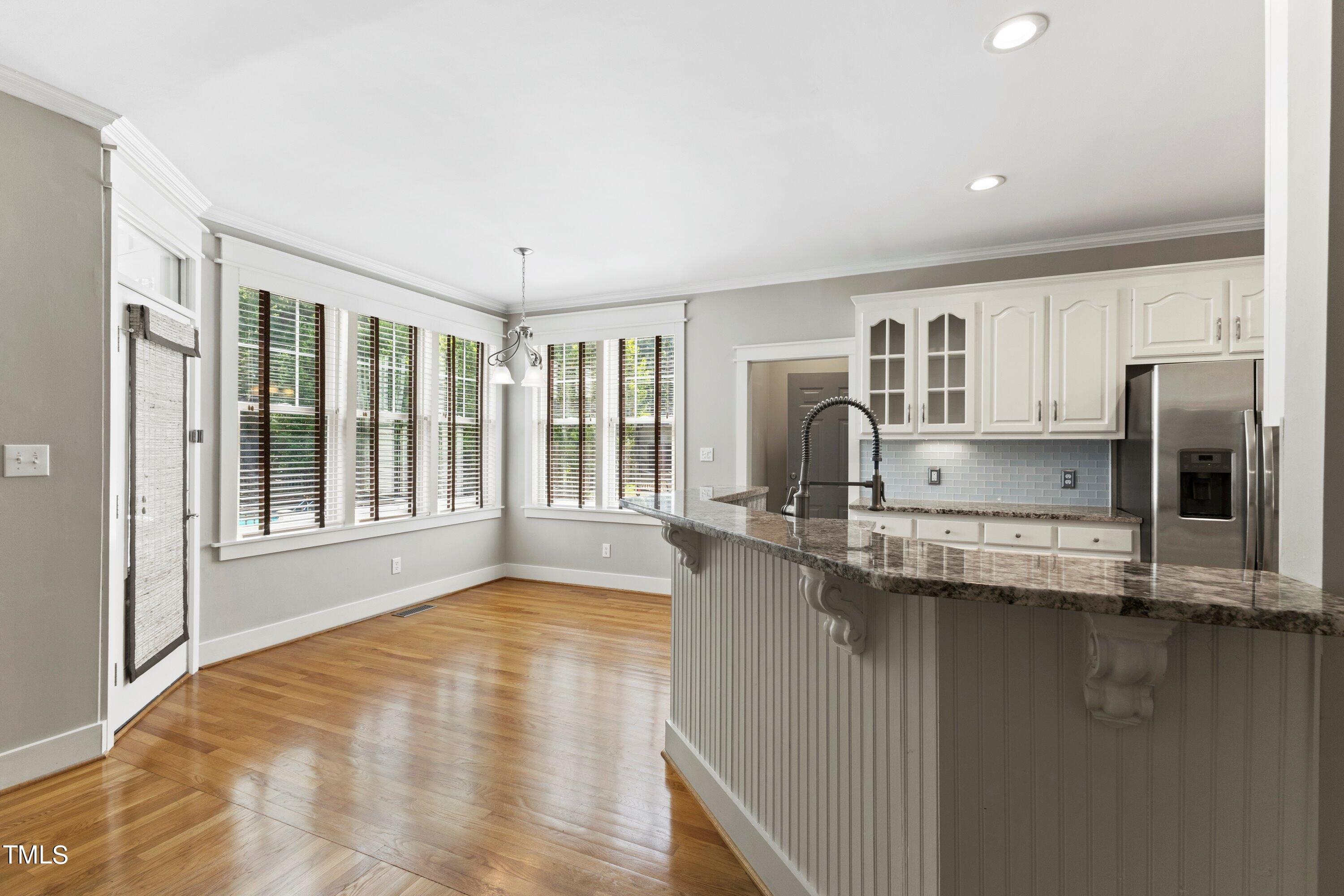 7408 Lakefall Drive Wake Forest, NC 27587 - Photo 20 of 65 a kitchen with stainless steel appliances granite countertop a sink and cabinets