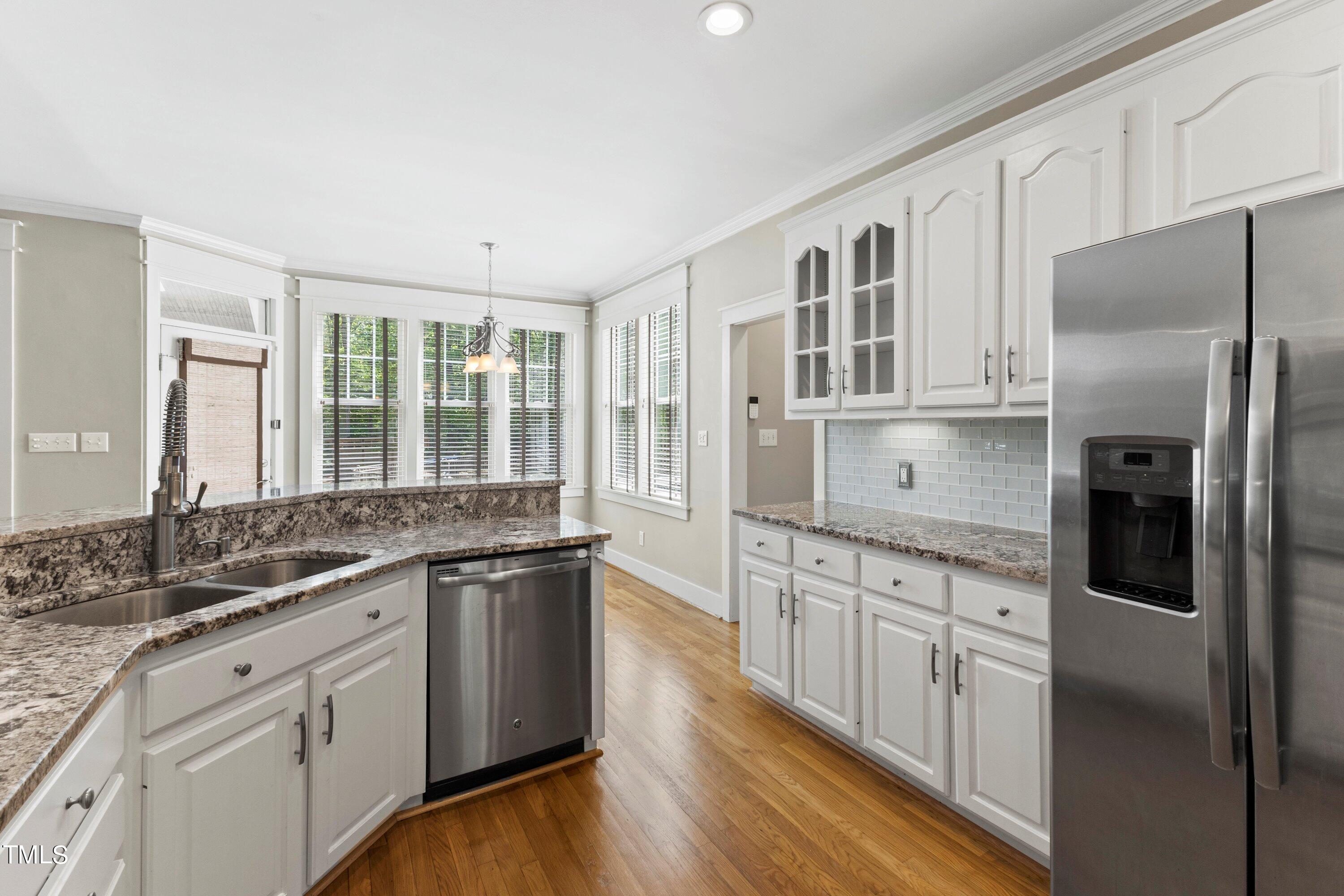 7408 Lakefall Drive Wake Forest, NC 27587 - Photo 24 of 65 a kitchen with stainless steel appliances granite countertop a stove and a refrigerator