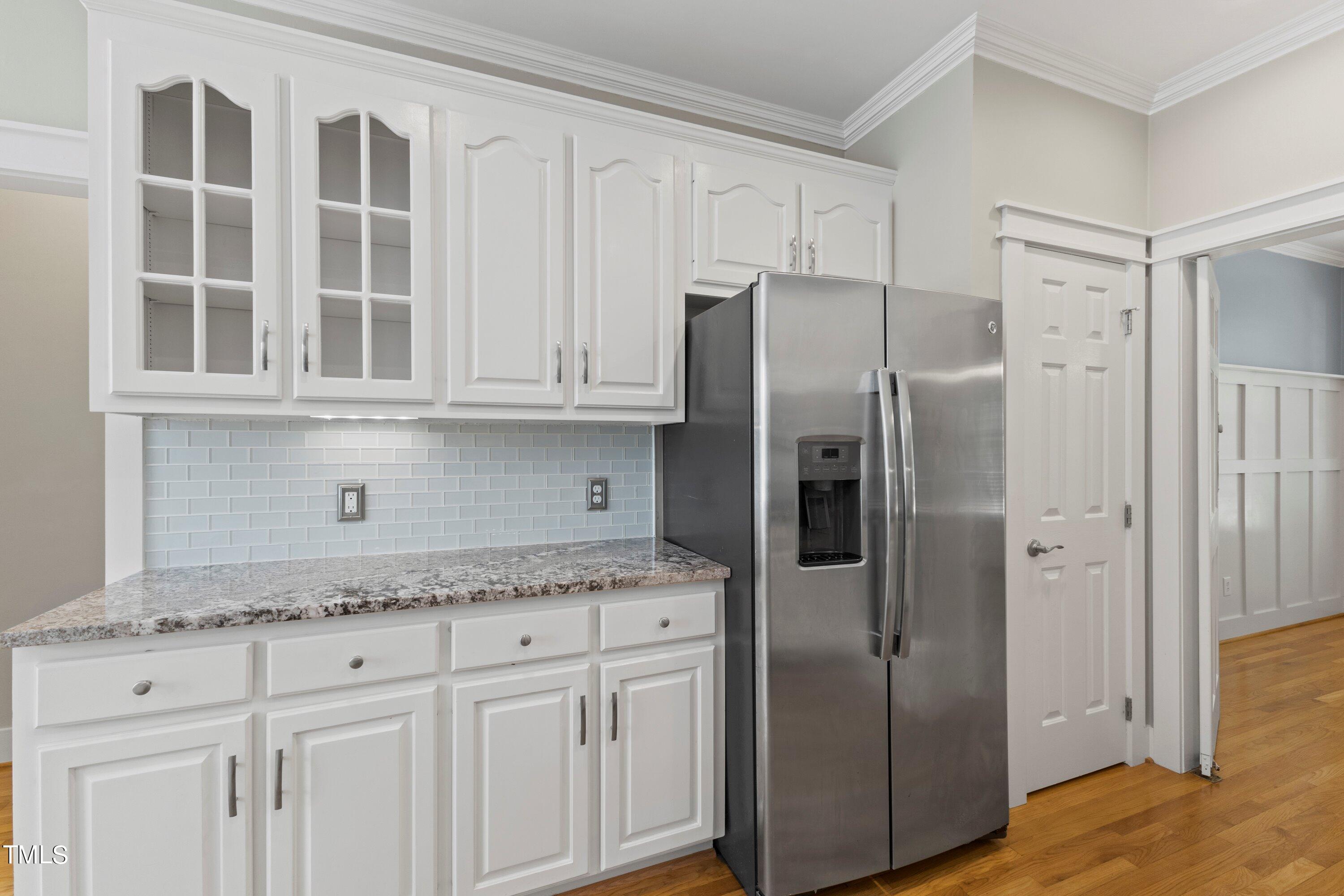 7408 Lakefall Drive Wake Forest, NC 27587 - Photo 25 of 65 a kitchen with stainless steel appliances granite countertop a refrigerator and cabinets
